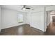 Bedroom with wood floors, ceiling fan, a window, and closet with folding doors at 1003 Edmund Ave, Dundee, FL 33838