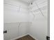 Walk-in closet featuring wood flooring and metal shelving for optimal storage and organization at 1003 Edmund Ave, Dundee, FL 33838