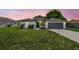 Charming single-story home with stucco exterior, arched windows, and a well-maintained lawn at 1003 Edmund Ave, Dundee, FL 33838