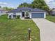 Well-maintained home with a manicured lawn and two-car garage at 1003 Edmund Ave, Dundee, FL 33838