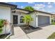 Inviting entrance featuring a well manicured lawn, modern lighting and walkway at 1003 Edmund Ave, Dundee, FL 33838