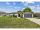 Charming home featuring well-manicured lawn and front landscaping and an attached two car garage at 1003 Edmund Ave, Dundee, FL 33838