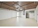 Garage with painted floors and ceilings, utility closet, and a white entry door at 1003 Edmund Ave, Dundee, FL 33838