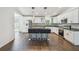 Beautiful kitchen boasting stainless steel appliances, bar seating, and chic pendant lighting at 1003 Edmund Ave, Dundee, FL 33838