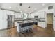 Contemporary kitchen featuring stainless steel appliances, bar seating, and stylish pendant lighting at 1003 Edmund Ave, Dundee, FL 33838
