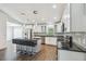 Modern kitchen features white cabinets, stainless steel appliances, and breakfast bar seating at 1003 Edmund Ave, Dundee, FL 33838