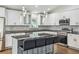Modern kitchen featuring a center island with seating, pendant lights and stainless steel appliances at 1003 Edmund Ave, Dundee, FL 33838
