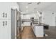 Bright kitchen features stainless steel appliances, an island with bar seating, and modern pendant lighting at 1003 Edmund Ave, Dundee, FL 33838
