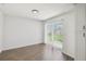 Bright living room with sliding glass doors and hardwood floors offers a seamless indoor-outdoor transition at 1003 Edmund Ave, Dundee, FL 33838