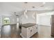 Open concept living area with vaulted ceiling, tile floors, and view of front entrance and water at 1003 Edmund Ave, Dundee, FL 33838