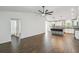 Spacious open-concept living room with dark wood-look tile flooring and modern fixtures at 1003 Edmund Ave, Dundee, FL 33838