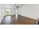 Inviting living room bathed in natural light, boasting tile flooring and a modern ceiling fan at 1003 Edmund Ave, Dundee, FL 33838