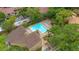Aerial view of a community pool surrounded by trees, chairs, and manicured grounds at 1038 E Michigan St # 1, Orlando, FL 32806