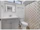 Bathroom with a gray vanity, neutral patterned shower curtain, and updated fixtures at 1038 E Michigan St # 1, Orlando, FL 32806