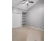 Bedroom features closet and corner shelving, and neutral colored walls and carpeting at 1038 E Michigan St # 1, Orlando, FL 32806
