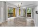 Dining area has hardwood floors, mirrored wall, natural light, and balcony access through sliding glass doors at 1038 E Michigan St # 1, Orlando, FL 32806
