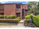 Charming townhome features an inviting walkway, a private balcony, and verdant landscaping at 1038 E Michigan St # 1, Orlando, FL 32806