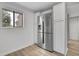 Kitchen features stainless steel refrigerator, white cabinets, hardwood floors and bright lighting at 1038 E Michigan St # 1, Orlando, FL 32806
