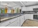 Bright kitchen with a marble countertop, mosaic tile backsplash, and stainless steel appliances at 1038 E Michigan St # 1, Orlando, FL 32806