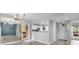 Open-concept living area with hardwood floors and kitchen access with a pass-through counter at 1038 E Michigan St # 1, Orlando, FL 32806