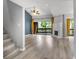 Bright living room with a stone fireplace, wood floors, and sliding doors to the balcony at 1038 E Michigan St # 1, Orlando, FL 32806
