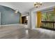 Spacious living room with hardwood floors, balcony access, and bright lighting fixtures at 1038 E Michigan St # 1, Orlando, FL 32806