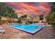 This community pool with a brick patio and chairs offers a relaxing outdoor space at 1038 E Michigan St # 1, Orlando, FL 32806