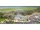 Community clubhouse featuring a pond, parking, and mature trees at 2613 Drew Cir, The Villages, FL 32163