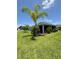 Beautiful backyard featuring mature landscaping surrounding a screened lanai at 2613 Drew Cir, The Villages, FL 32163