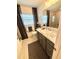 Bathroom featuring a shower and gray vanity with marble countertops at 2613 Drew Cir, The Villages, FL 32163