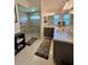 Modern bathroom with glass shower, gray cabinetry, and marble countertops at 2613 Drew Cir, The Villages, FL 32163