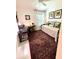 Cozy bedroom with daybed, desk, bright window, and unique art pieces at 2613 Drew Cir, The Villages, FL 32163