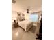 Comfortable bedroom featuring a large bed, soft lighting, and sheer curtains at 2613 Drew Cir, The Villages, FL 32163