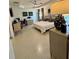 Spacious bedroom featuring tile floors, tray ceilings, and desk area at 2613 Drew Cir, The Villages, FL 32163