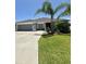 Charming single-story home with a well-manicured lawn and attached two-car garage at 2613 Drew Cir, The Villages, FL 32163