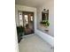 Welcoming front porch with decorative plants and a charming mirror at 2613 Drew Cir, The Villages, FL 32163