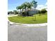 Well-maintained front yard with lush green grass and mature palm trees on a corner lot at 2613 Drew Cir, The Villages, FL 32163