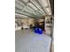 Spacious garage featuring epoxy flooring, storage, and lots of lighting at 2613 Drew Cir, The Villages, FL 32163