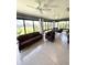 Bright sunroom with comfortable seating, ceiling fans and views of the landscaped exterior at 2613 Drew Cir, The Villages, FL 32163