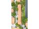 Drone shot of townhomes displaying their terracotta roofs, lush trees and proximity to the lake at 6133 Metrowest Blvd # 105, Orlando, FL 32835