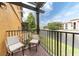 Private balcony overlooking water features two chairs with outdoor seating, ideal for relaxation at 6133 Metrowest Blvd # 105, Orlando, FL 32835