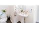 Clean half bathroom with a modern sink, toilet, decorative plants, and neutral decor at 6133 Metrowest Blvd # 105, Orlando, FL 32835