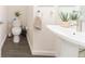 Cozy half bathroom featuring a modern sink, toilet, and decorative plants at 6133 Metrowest Blvd # 105, Orlando, FL 32835