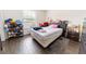 This bedroom offers great natural light, dark wood flooring, and a ceiling fan at 6133 Metrowest Blvd # 105, Orlando, FL 32835