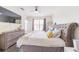 This primary bedroom offers great natural light, a ceiling fan, and beautiful gray wood flooring at 6133 Metrowest Blvd # 105, Orlando, FL 32835