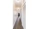 Long hallway with tile flooring, white walls, and closet doors at 6133 Metrowest Blvd # 105, Orlando, FL 32835