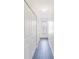 Bright hallway featuring gray wood-look tile floors, storage closet and a decorative light fixture at 6133 Metrowest Blvd # 105, Orlando, FL 32835
