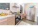 Modern kitchen features stainless steel appliances, sleek wood cabinets, and bright countertops at 6133 Metrowest Blvd # 105, Orlando, FL 32835