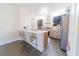 Bright kitchen with stainless steel appliances, wooden cabinets, breakfast bar, and modern light fixtures at 6133 Metrowest Blvd # 105, Orlando, FL 32835