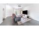 Bright living room with a cozy couch, television, and a decorative mirror at 6133 Metrowest Blvd # 105, Orlando, FL 32835